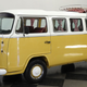 A photo of a bright yellow classic VW bus.